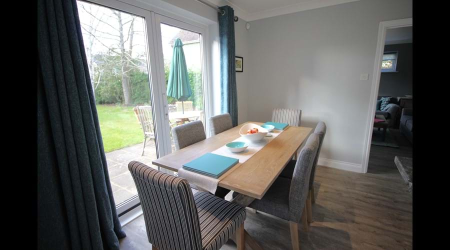 Dining table with seating for 6. Garden table, chairs & umbrella.