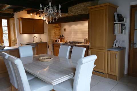 Limestone kitchen table in the light oak fitted kitchen