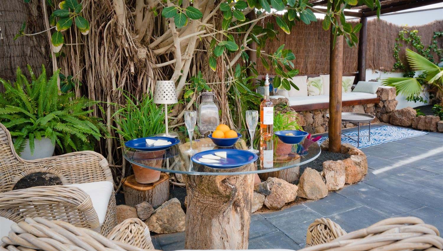 Outdoor dining on a tree stump table at Finca Botanico in Lanzarote
