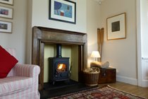 Cosy up by our wood burning stove in the lounge