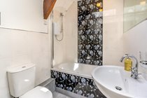 Bath with shower over