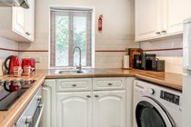 Kitchen with Washing Machine, Fridge Freezer and Microwave Oven