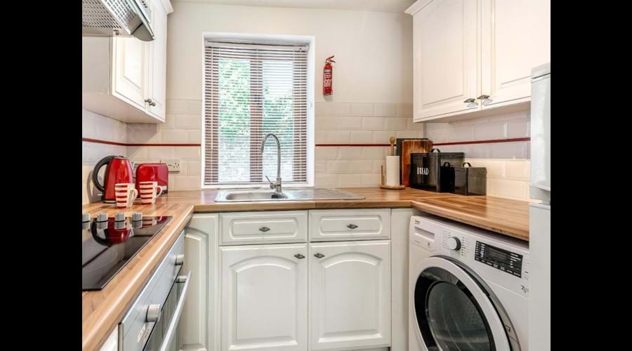 Kitchen with Washing Machine, Fridge Freezer and Microwave Oven