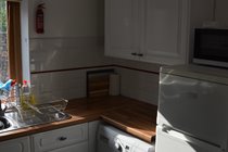Kitchen with Washing Machine, Fridge Freezer and Microwave Oven