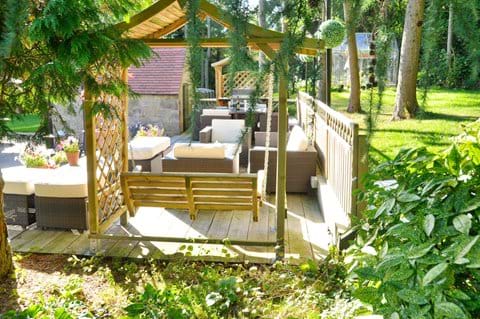 secluded outdoor seating area in beautiful mature gardens