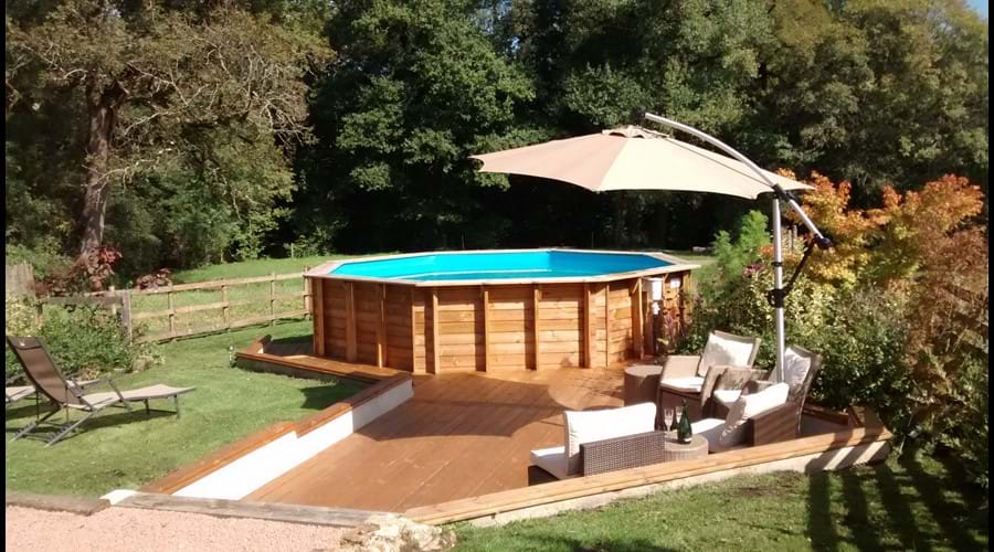 Woods and the river are the ideal backdrop to the pool in River View Cottage