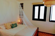 Bedroom with mosquito net for those who like to sleep with windows open