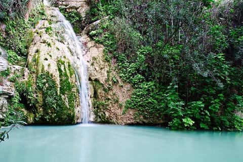 waterfall over rocks into Aphrodite baths