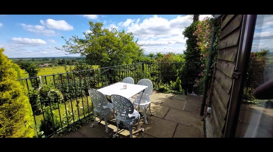 Raised terrace, overlooking the lawned cottage garden and open fields