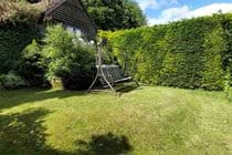 Lawn area of the rear garden, looking back toward the terrace and cottage