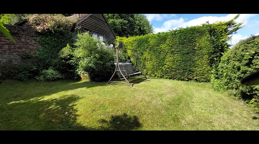 Lawn area of the rear garden, looking back toward the terrace and cottage