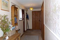 Hallway with a selection of OS maps to borrow, books, games and leaflets