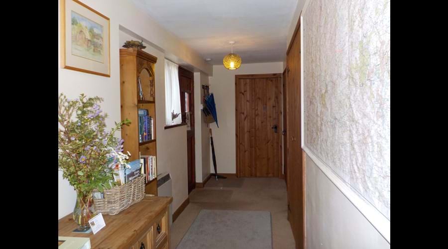 Hallway with a selection of OS maps to borrow, books, games and leaflets