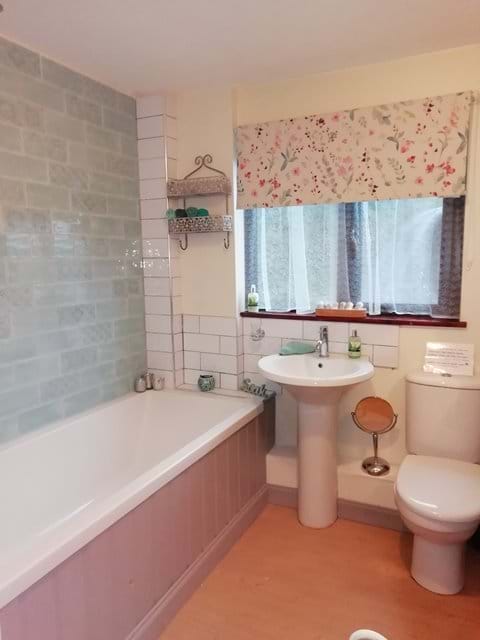 Main Bathroom with shower over the bath.  There