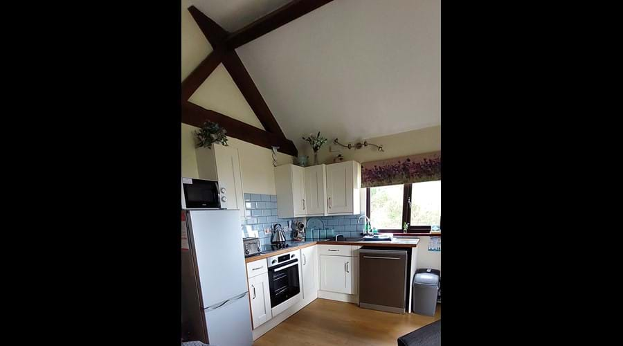 Kitchen with dish washer, oven/hob, 60/40 fridge freezer.  There