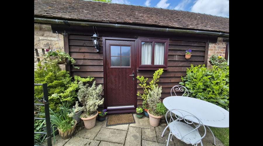 Main access from the front, with informal eating area and lawn adjacent