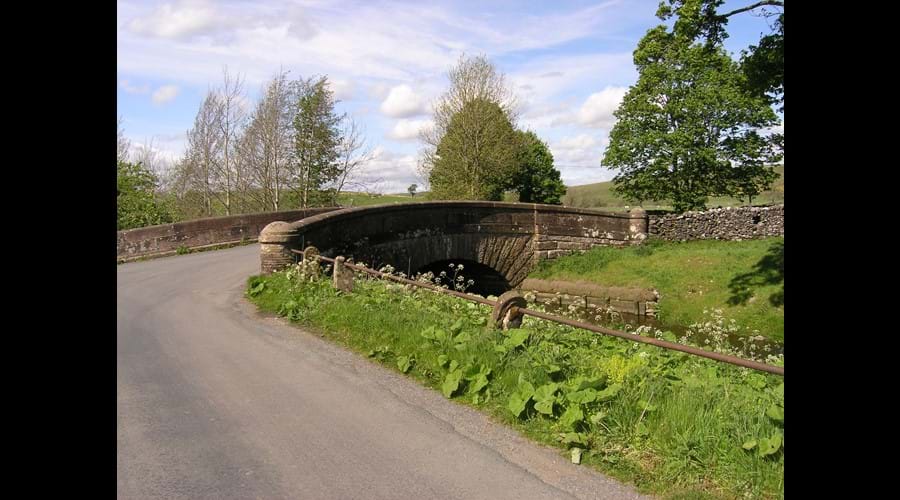 Turn right over this bridge and immediately right again