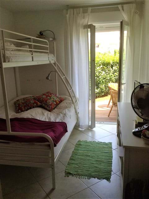 Bedroom 2 with "Family bunk-bed" (140+90). AC and storage. Terrace access