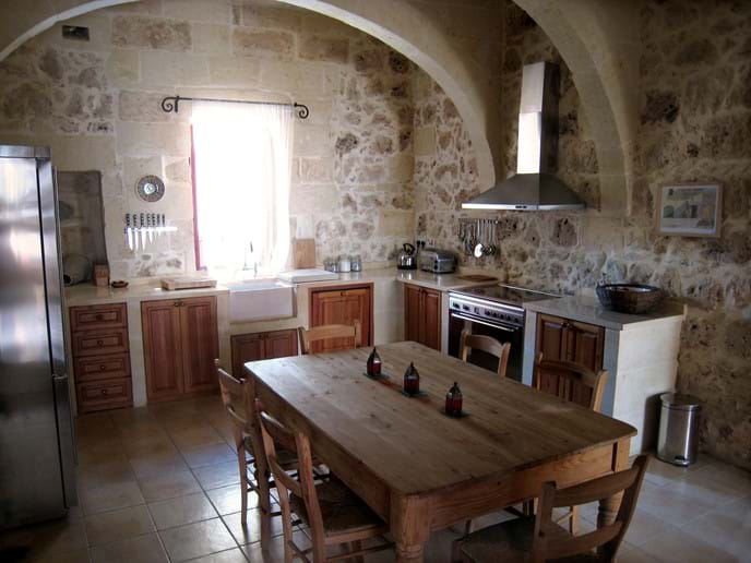 Kitchen with Limestone worktops, Smeg appliances and farmhouse table
