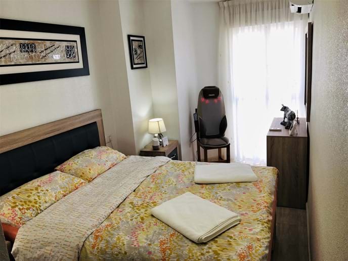 Holiday apartment - master bedroom: luxury bed, HoMedics massager and aircon