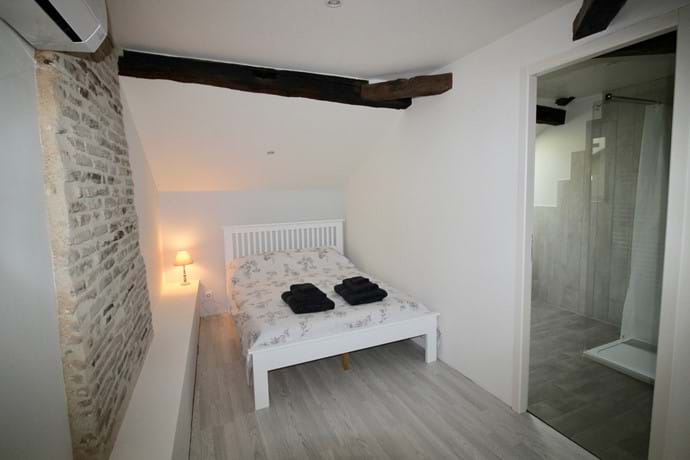Family Bedroom with feature chimney breast - view to ensuite