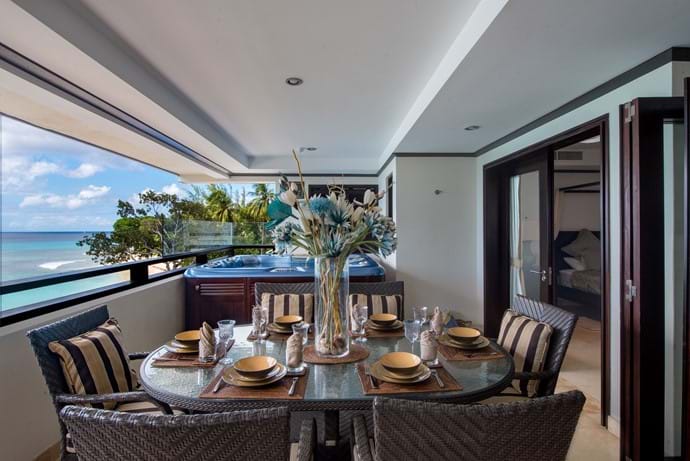 Dining area and hot tub on the balcony of Coral Cove 12. Views of Paynes bay beach and the Caribbean Sea.