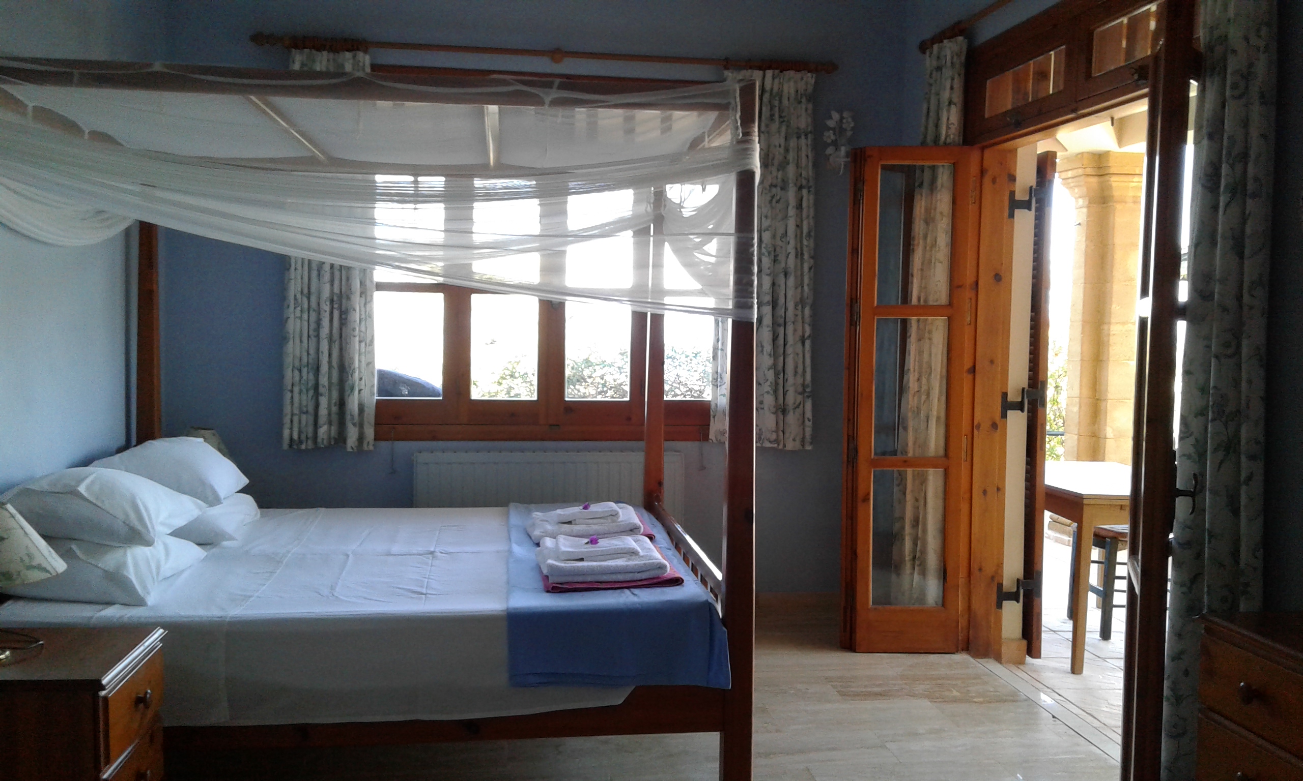 Master bedroom with four poster superking sized bed and french windows to pool terrace