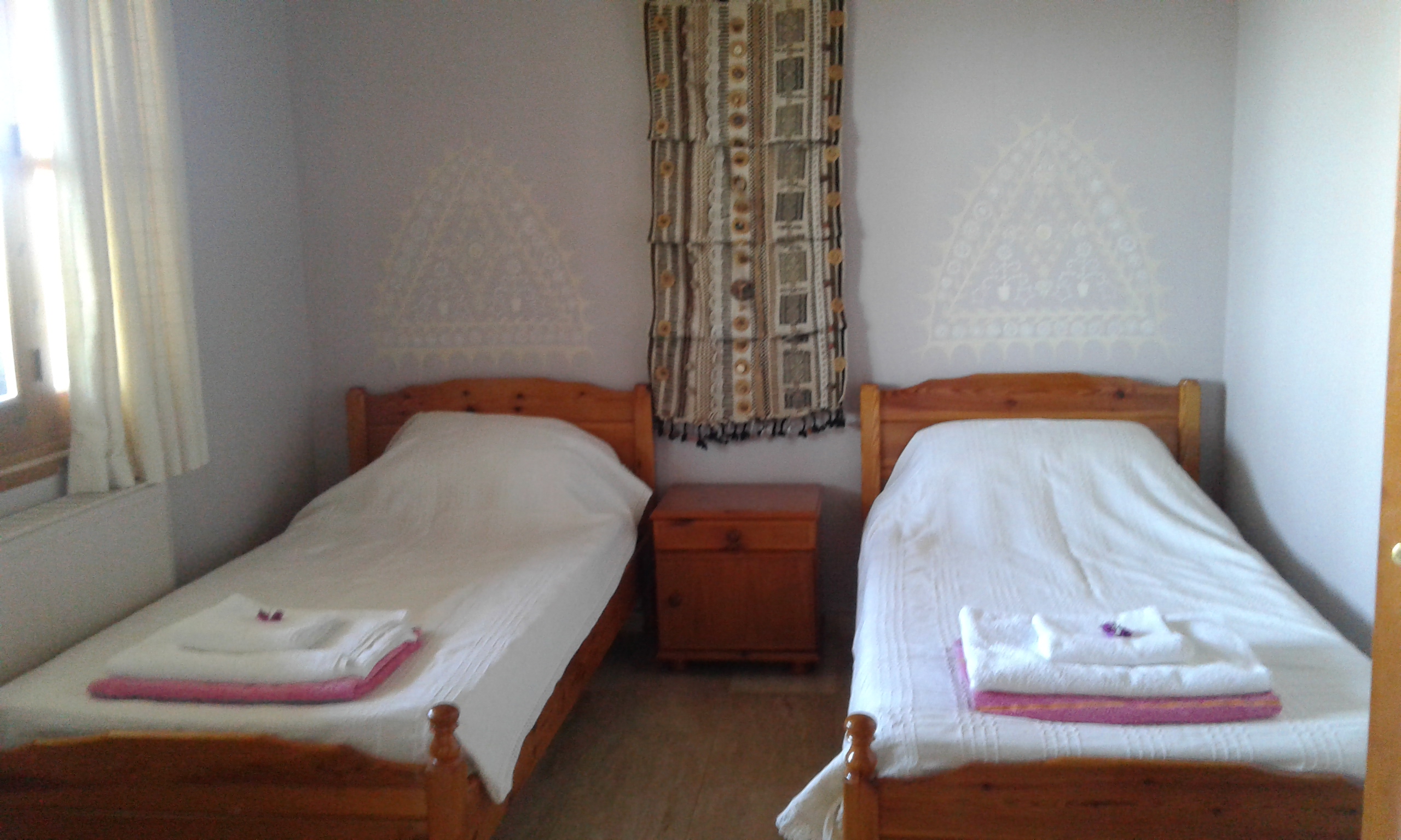 Second bedroom with twin beds and french windows to the terrace