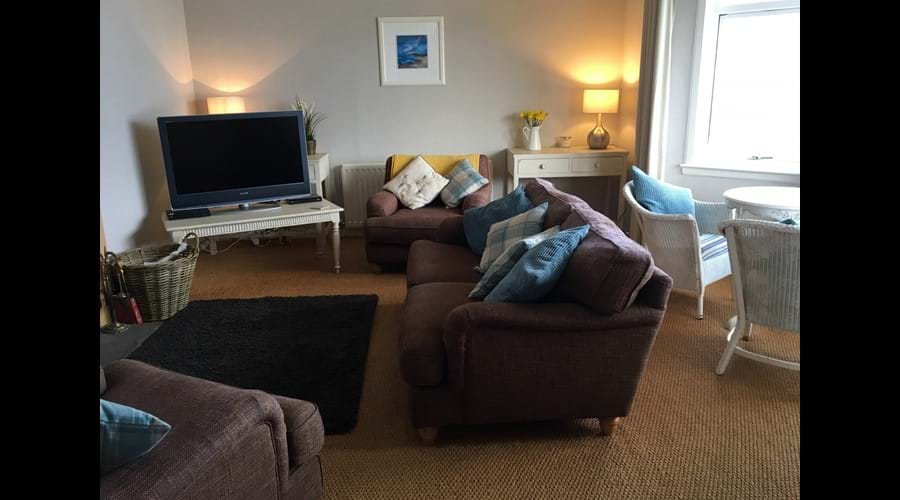 Spacious lounge showing bay window seating.