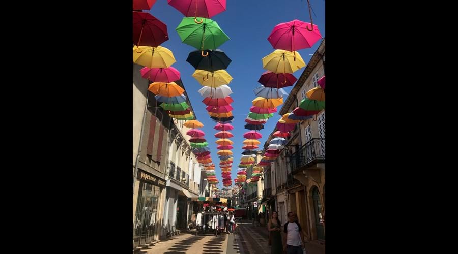 View of colorful umbrellas on street in Sainte=Foy-La-Grande