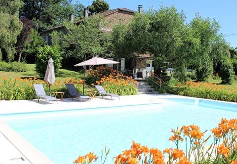 Large pool surrounded by garden and orange day lilies