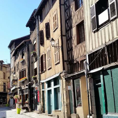 Old narrow houses on street in butchery quarter with wood effect on front