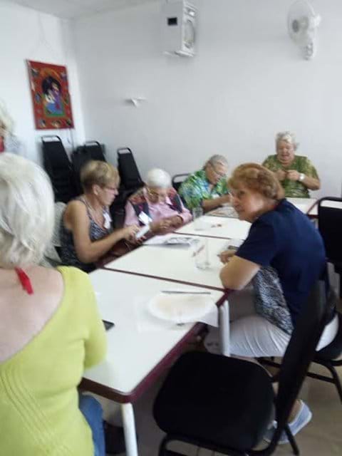 Kerry, Lynne, Carol and others taking part in a quiz.