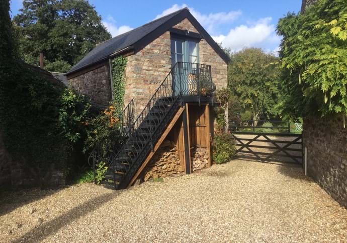 Leat Cottage, with metal steps up to first floor sitting/dining room