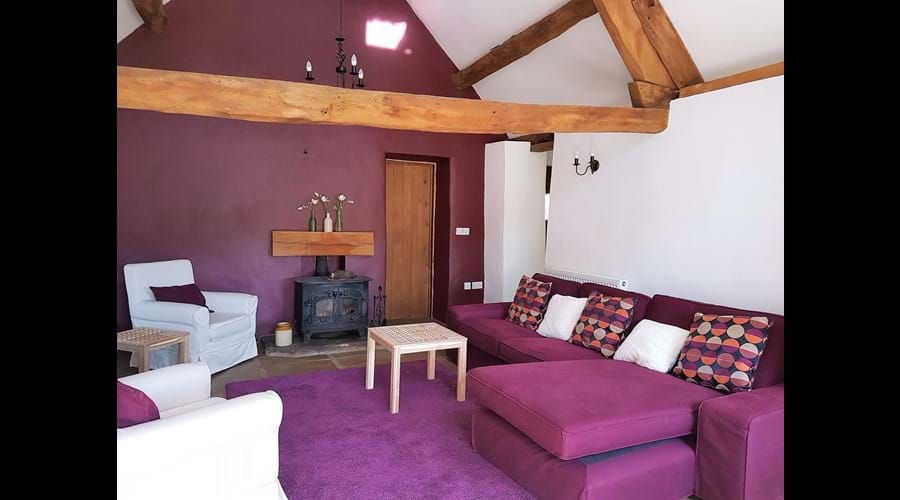 Spacious living area with woodburning stove, 32 inch flat screen TV and bags of character.