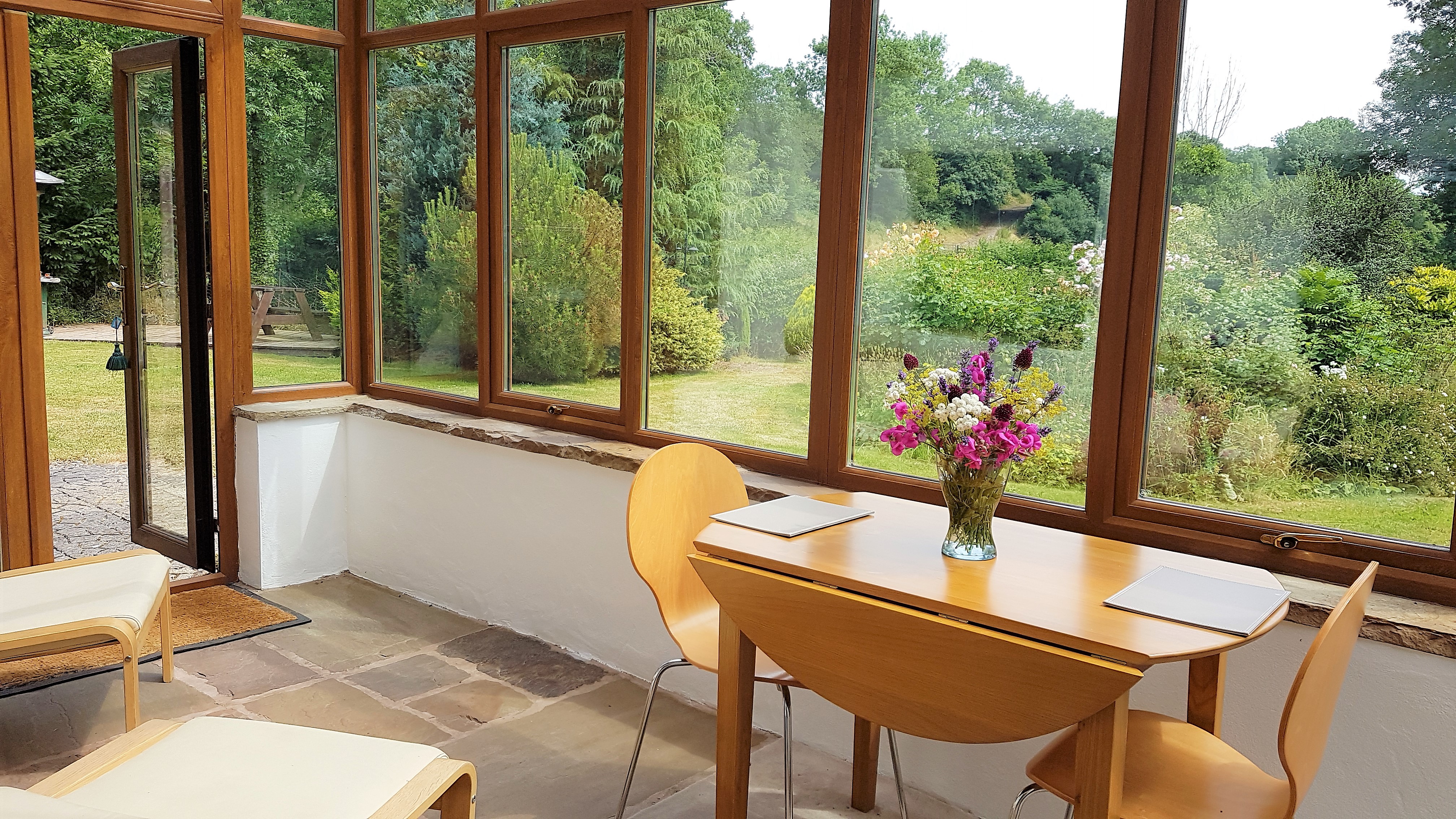 Dine in the sun room or relax in the easy chairs while you watch the garden wildlife.