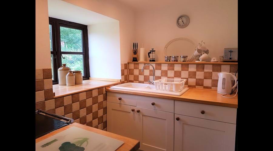 Well-equipped kitchen featuring a walk in larder. The utility room has an under counter freezer, dishwasher and washer-drier.