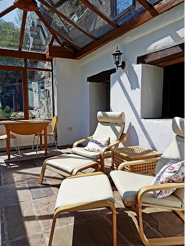 The sun room is off the living room and overlooks the beautiful, south-facing gardens.