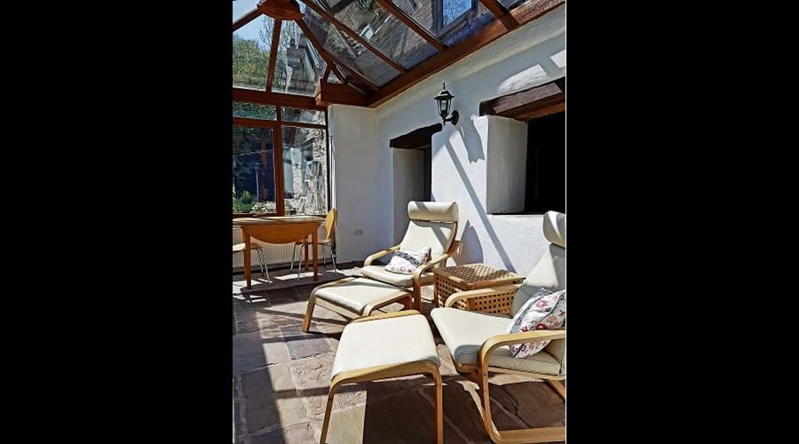 The sun room is off the living room and overlooks the beautiful, south-facing gardens.