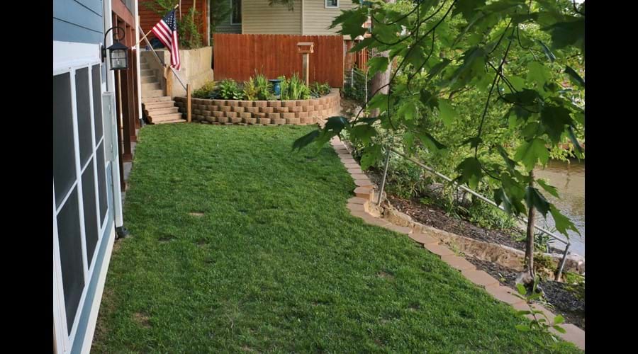 Lower floor walks out onto a covered patio and grass area