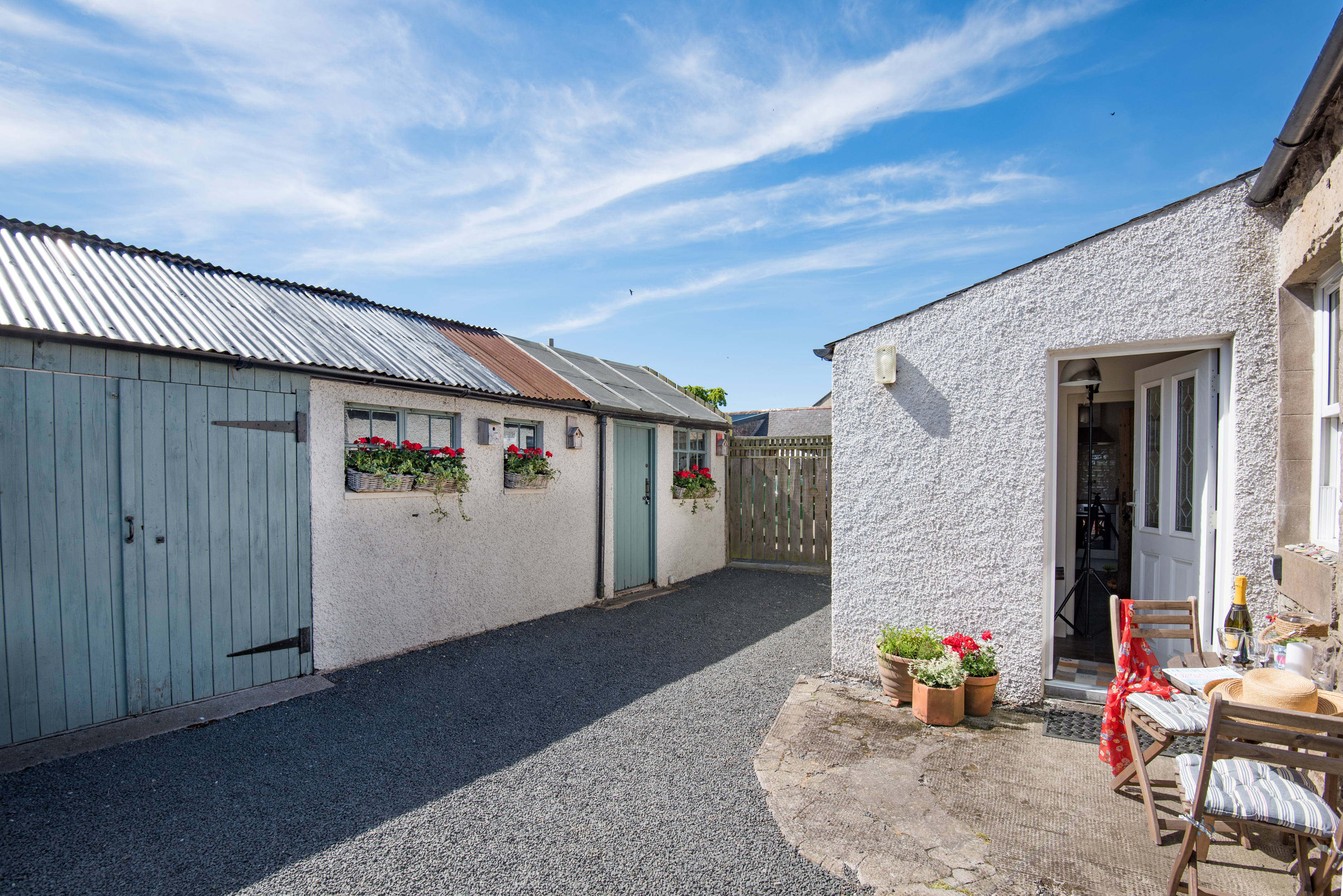 At the rear of the cottage: a sunny spot to sit out in and securely enclosed to keep our canine guests safe. The outbuilding houses logs and bicycles for guests’ use.