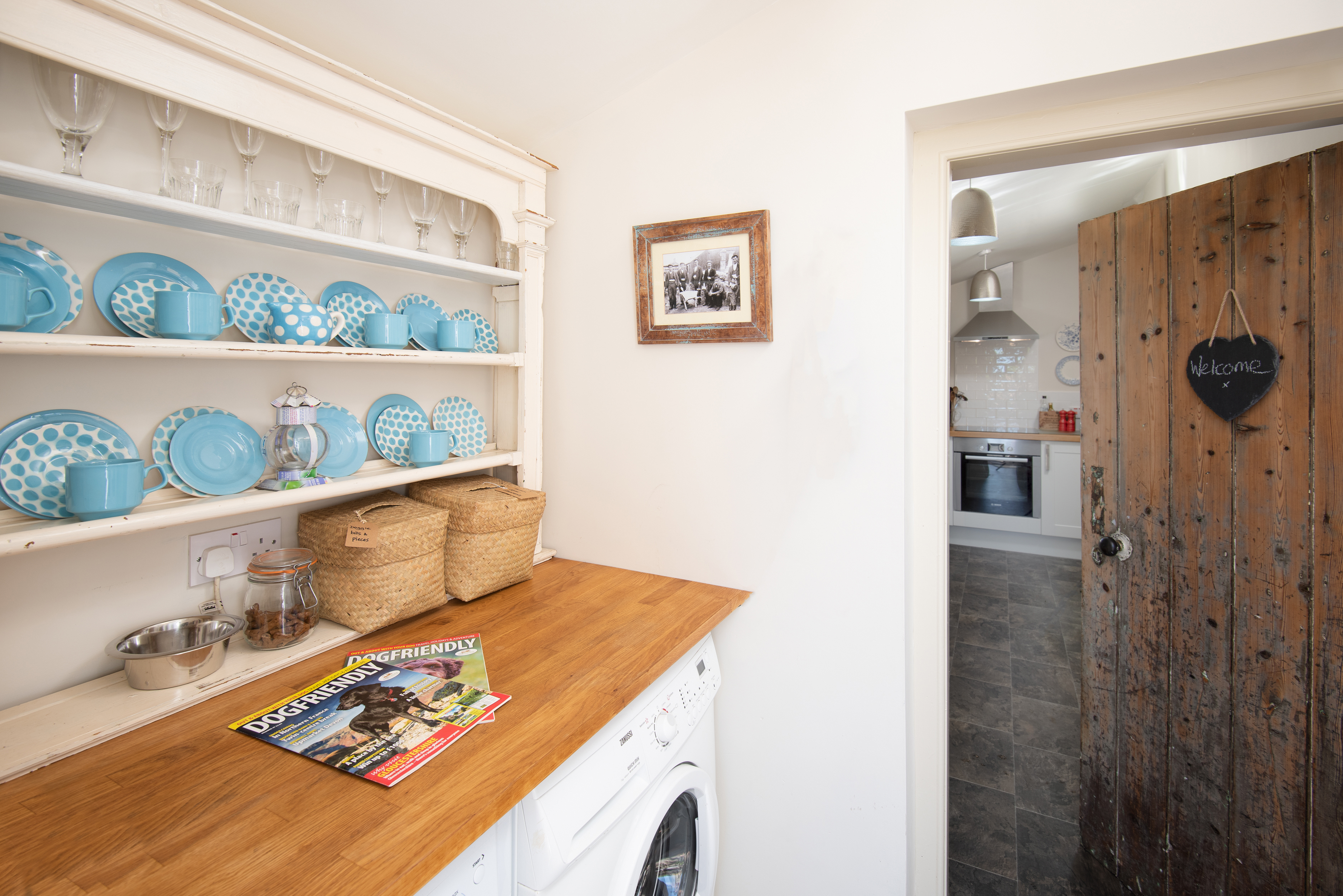 Through the back door into the utility room which houses the washing machine, tumble dryer, dog bowls and, of course, dog treats!