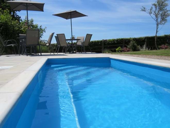 Heated plunge pool and sun lounge area