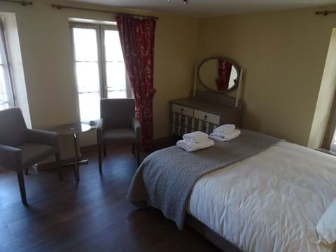 2nd floor bedroom with seating and views over the main square