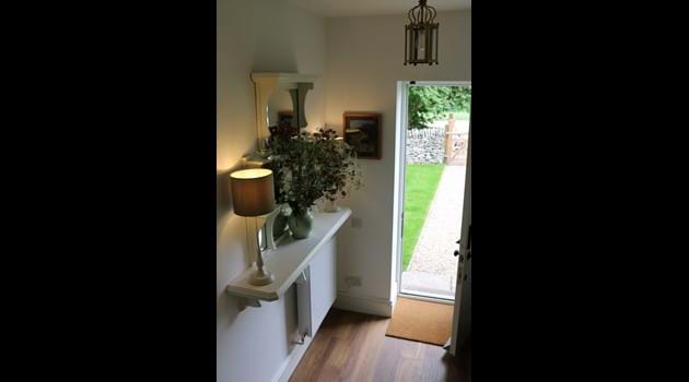 The entrance hall with coat-hanging under the stairs