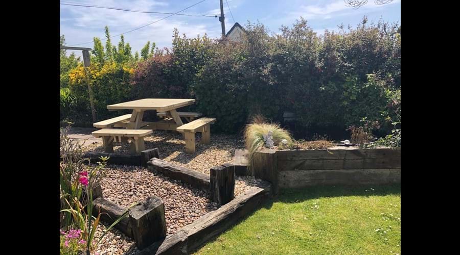 Wooden Picnic table positioned in the enclosed front garden