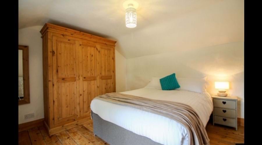 Bedroom with King size bed and large three door wardrobe