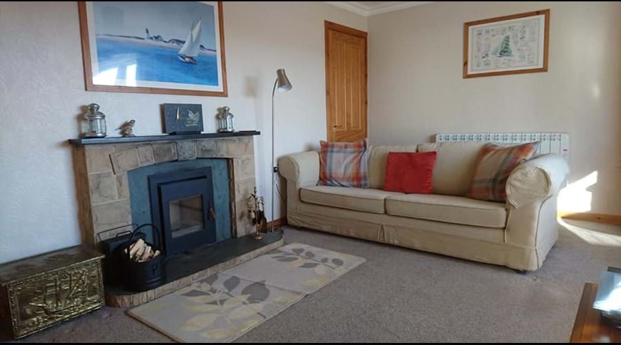 The Living room showing the log burning stove The living room showing the log burning inset stove