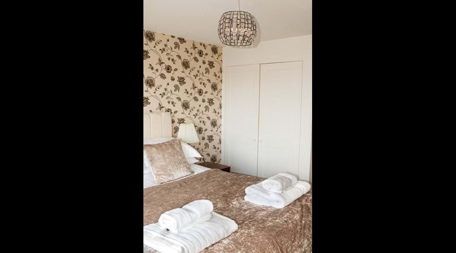 Top main bedroom with TV and built in wardrobe.