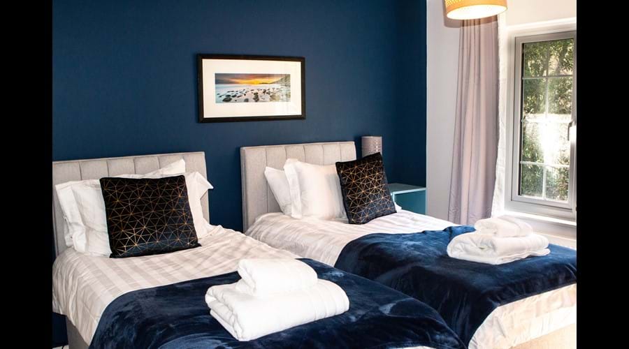 Top floor back bedroom with chest of drawers and TV. Beds can be made into superking on request.